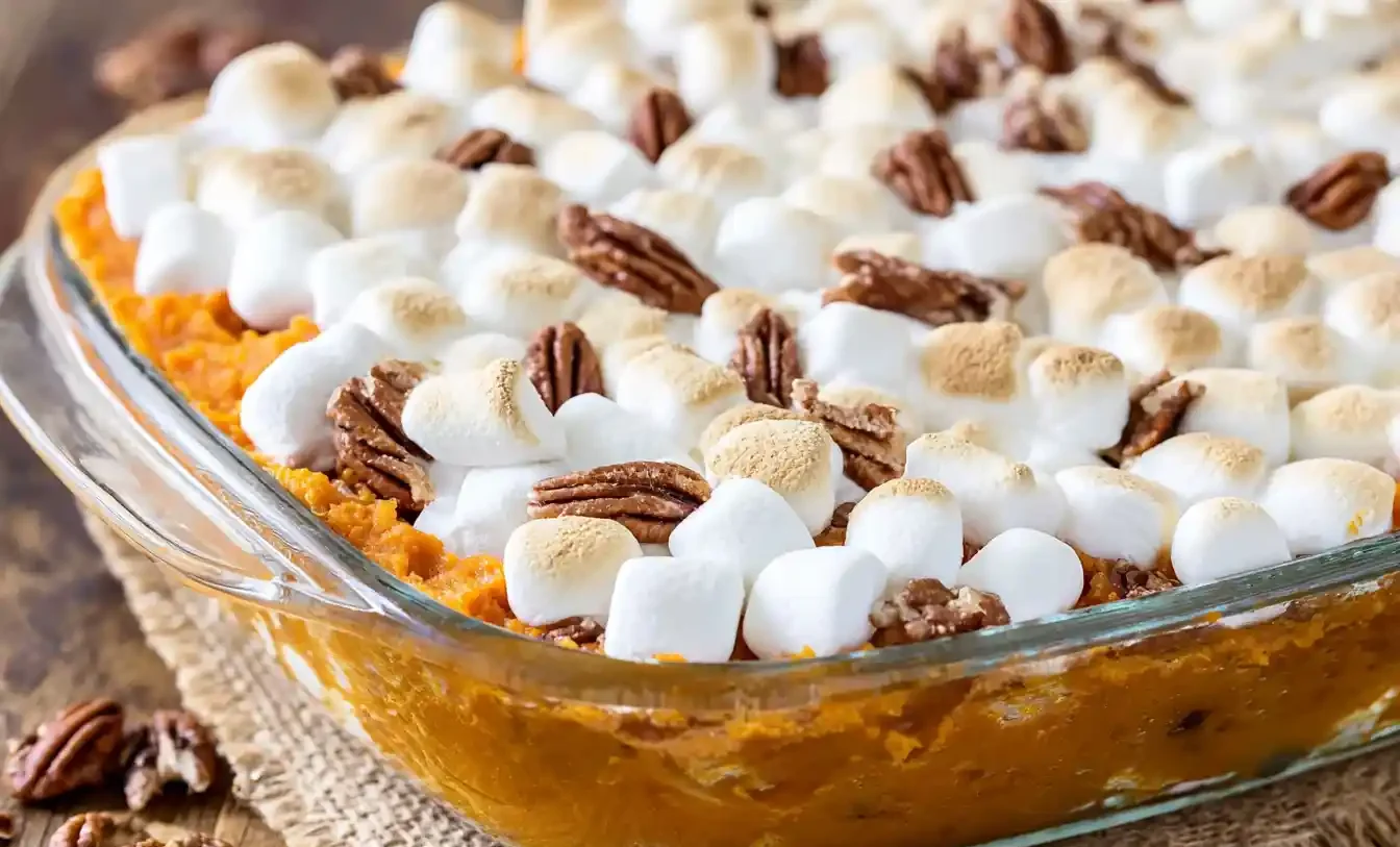 A close-up shot of a golden-brown Sweet Potato Casserole With Marshmallows, featuring perfectly toasted, gooey marshmallows on top.