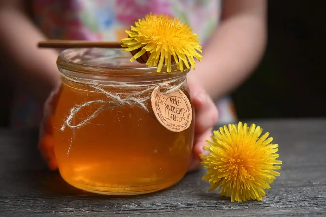 Child holding a jar of golden {{ $('Fetch Recipe Data').first().json["Main Keyword"] }} with fresh dandelions.