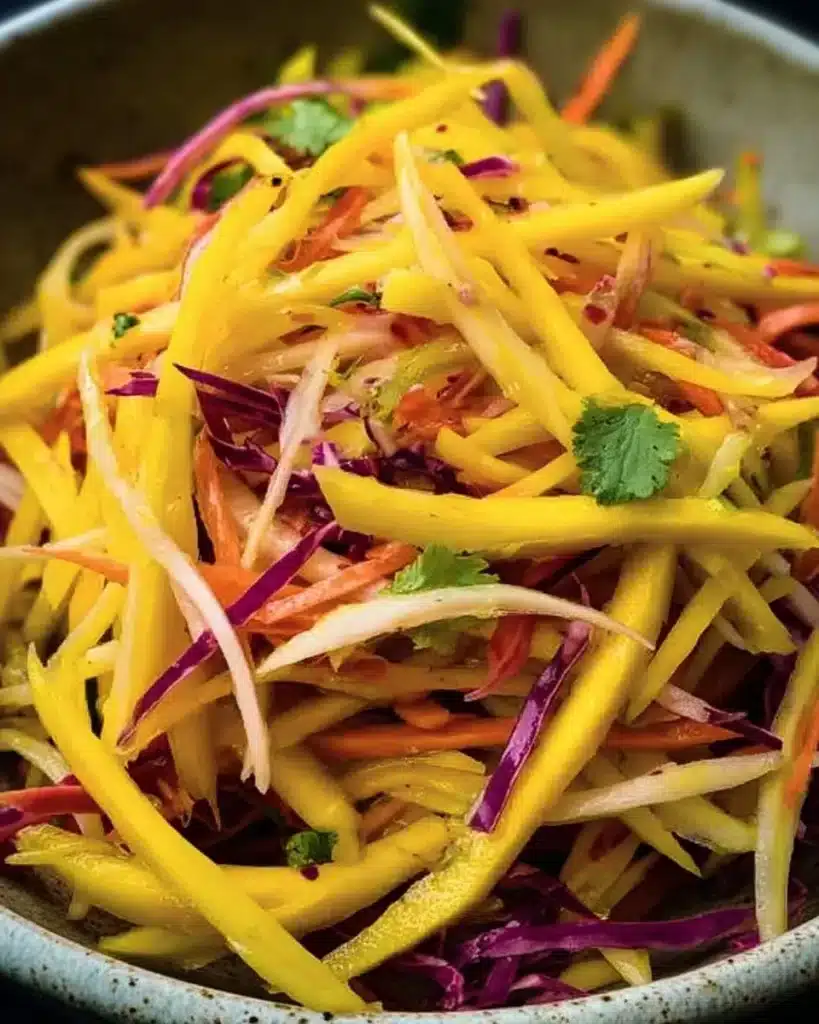 Vibrant mango slaw salad with fresh ingredients and colorful presentation.
